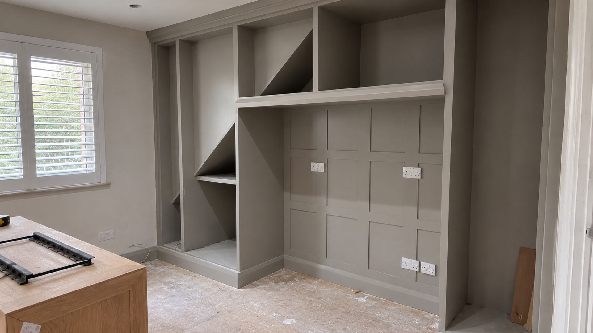 Painted alcove units and panelling built into a chimney breast